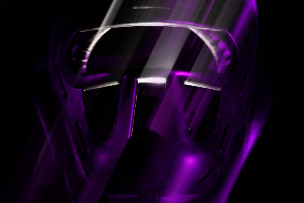 Sports protective helmet for martial arts in an aggressive style on a dark background with purple light.