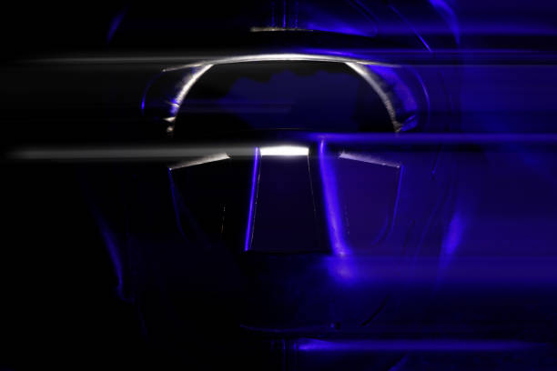 Sports protective helmet for martial arts in an aggressive style on a dark background glows with blue light.