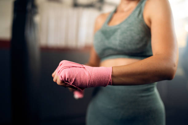 istock Unrecognizable woman, wrapping a bandage around her wrist before a kickbox practice 2173927210