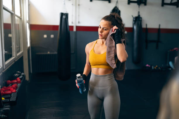 istock Young female kickboxer, wipe sweat with towel after an practice 2173928193