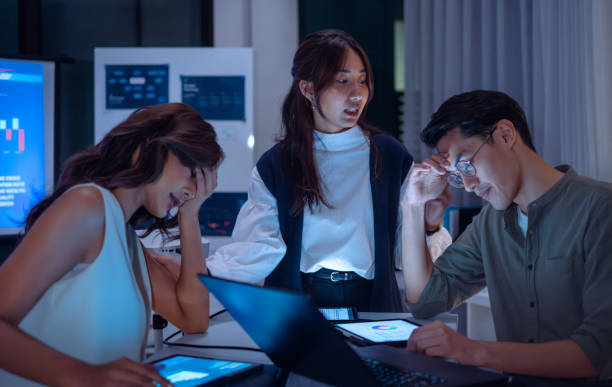 istock team of finance  get stress when analyzing economic crisis data and recession impacts during a late-night meeting in a office 2173928581