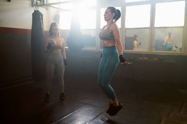 istock Caucasian female athlete exercise with a jumping rope 2173928690
