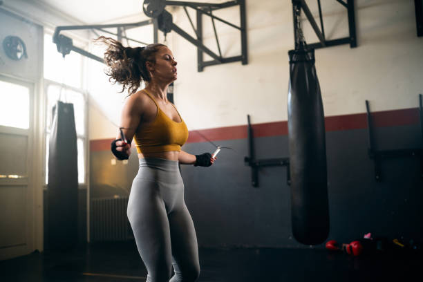 istock Female athlete exercise in the gym with a jumping rope 2173928693