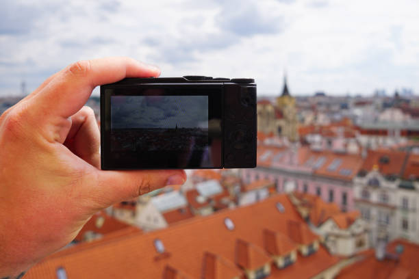istock Cropped hand holding a camera over a city 2173934597