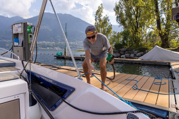 istock Man Docking a Boat at Lakeside Fuel Station 2173936620