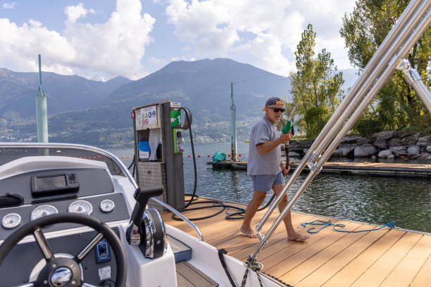 istock Man Skillfully Docking a Boat at the Tranquil Lakeside Fuel Station for Refueling 2173936621