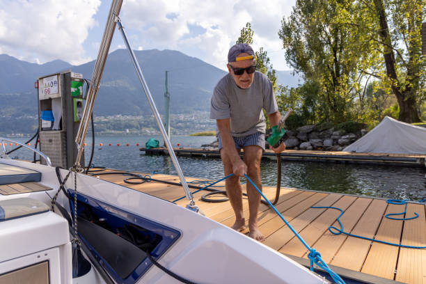 istock Man Skillfully Docking a Boat at the Tranquil Lakeside Fuel Station for Refueling 2173936627