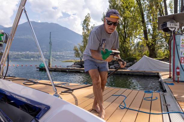 istock Man Docking a Boat at Lakeside Fuel Station 2173936667