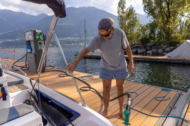 istock Man Docking a Boat at Lakeside Fuel Station 2173936705