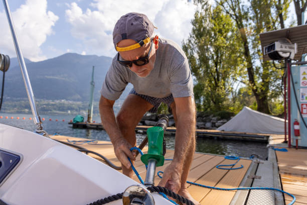 istock Man Docking a Boat at Lakeside Fuel Station 2173936706