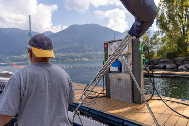 istock Man Steering a Boat Leaving a Dock 2173936926