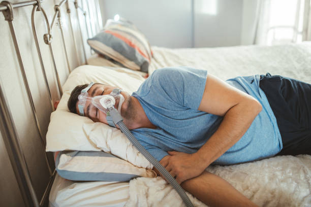 istock Man Sleeping With Cpap Machine on for Sleep Apnea 2173937481
