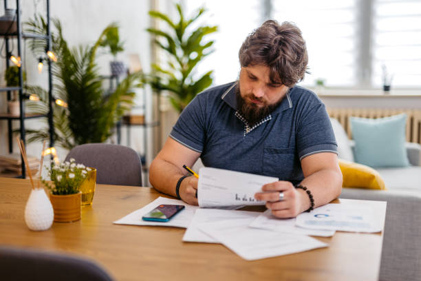 istock Young Man Checking His Finances At Home 2173938740
