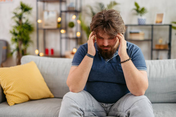 istock Young Man Having A Headache At Home 2173942677