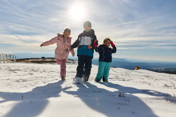 istock Happy kids enjoying winter snow 2173944887