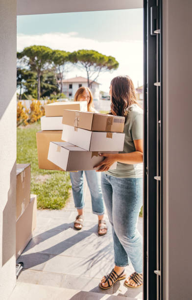 istock busy woman holding some boxes for the relocation 2173945079
