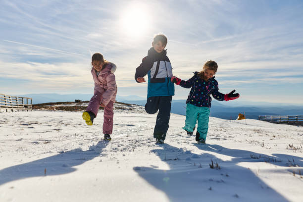 istock Happy kids enjoying winter snow 2173945370