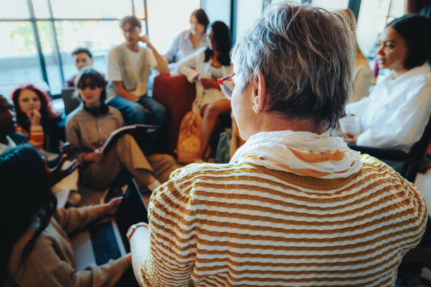 istock Teacher leading an informal class discussion with attentive students in a relaxed setting 2173947599