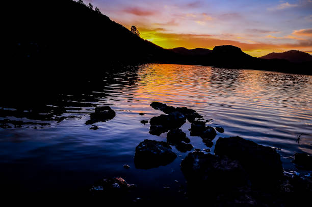 istock A beautiful sunset over a lake with a rocky shoreline 2173947792