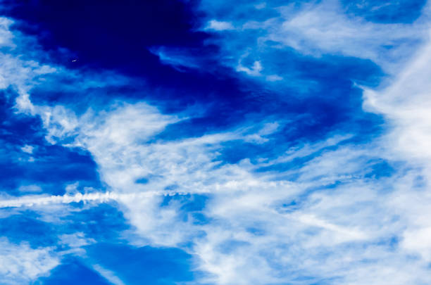 The sky is blue with a few clouds. The clouds are white and fluffy. The sky is clear and bright