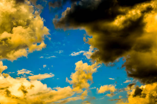 The sky is blue and has a few clouds. The clouds are yellow and black. The sky is very clear and bright