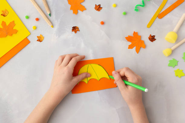 Orange paper umbrella kraft with kids autumn ideas for kindergarten diy step by step stock photo