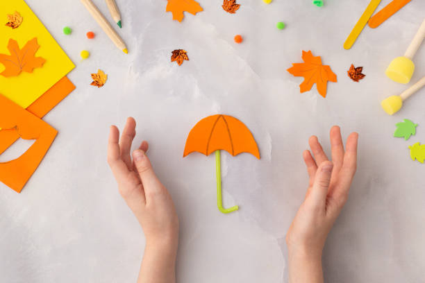 Orange paper umbrella kraft with kids autumn ideas for kindergarten diy step by step stock photo