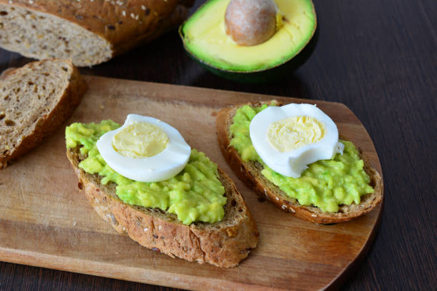 istock a cutting board with avocado and avocado sandwiches with egg on it 2173952085