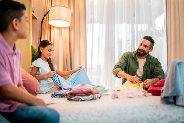istock Family talking and organizing clothes at home 2173952472