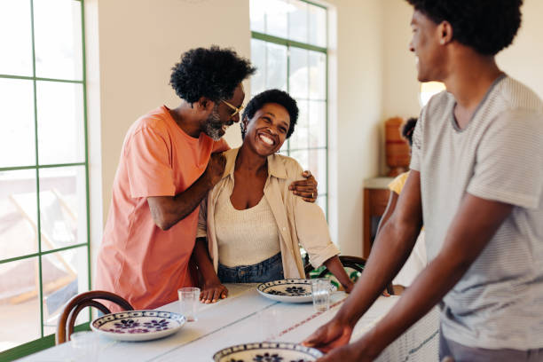 istock Brazilian family setting the table with plates for a breakfast meal 2173953005
