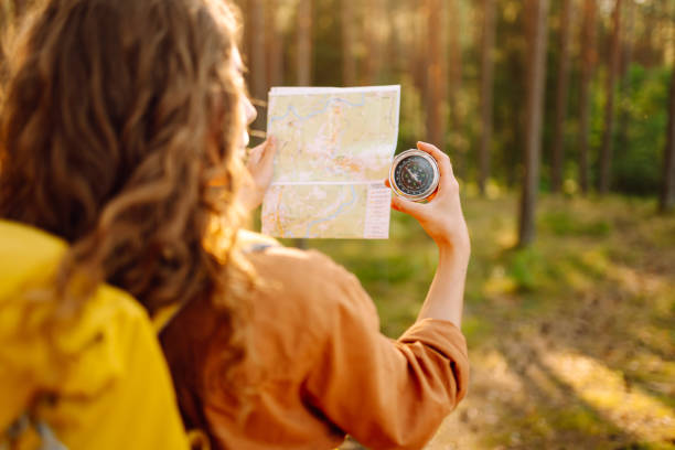 istock Exploring the forest with a map and compass during a sunny afternoon in a tranquil wooded area. 2173953202