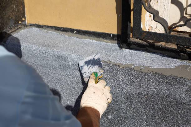 istock Worker in gloves restores the facade of building using spatula 2173954490
