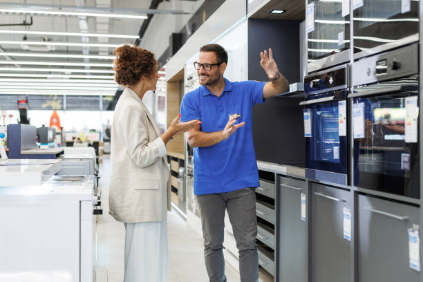 istock Salesperson assisting customer in modern appliance store setting 2173956896