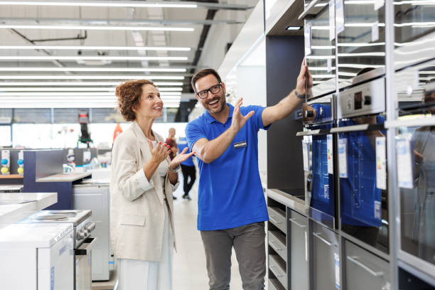 istock Salesperson assisting customer in modern appliance store 2173956962