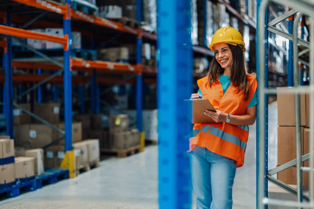 istock Female worker in warehouse as she leans on shelf, smiling. 2173958912