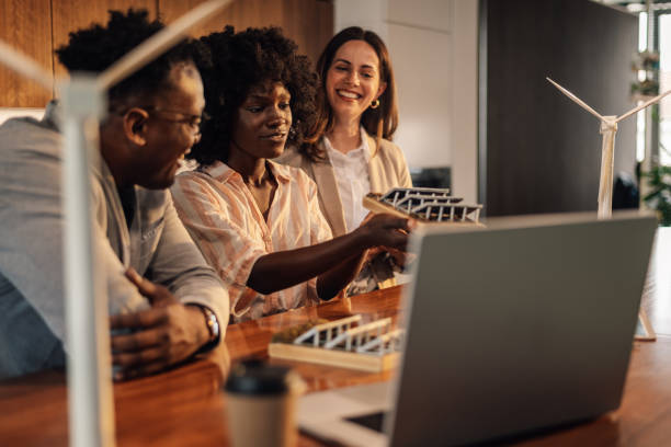 istock Interracial office crew with solar panels collaborating on sustainability 2173959073