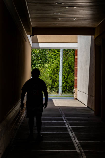 Queenstown, Maryland, USA  Sept 2, 2024 A man in silhouette walks in a passage at the Queenstown Premium Outlet