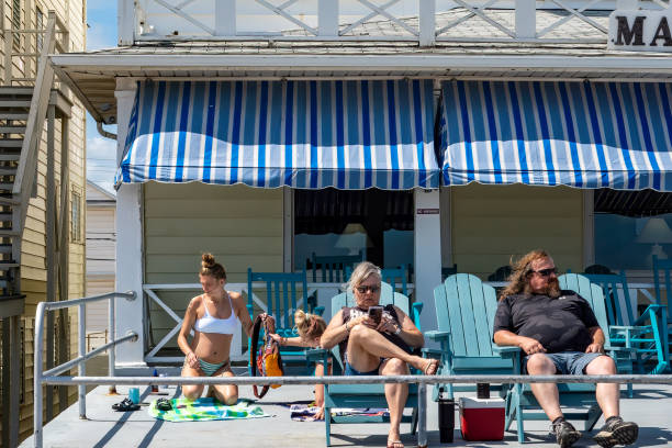 Ocean City, Maryland, USA Sept 3, 2024 A couple sit outside the Hotel Majestic on the   boardwalk during summer.