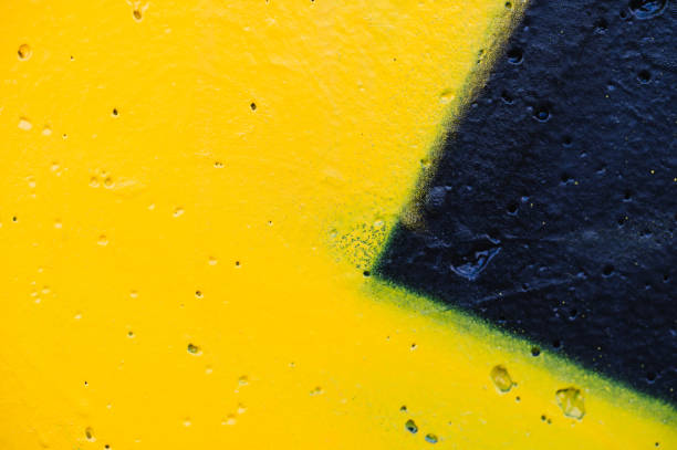 A soft gradient background transitioning from pink to yellow with small paint splatters on a textured surface. The colors blend smoothly, while the random specks and imperfections add a rustic and artistic charm to the image.