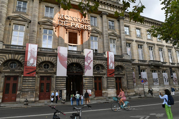 Paris, France - July 11, 2018: This photograph captures the courtyard of the École de Droit of Sorbonne in Paris, a historic site of legal studies. A gathering of people is seated on chairs, attending what appears to be an outdoor lecture, seminar, or discussion panel.