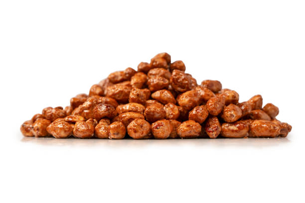 Tasty sweet roasted peanuts isolated on a white background.