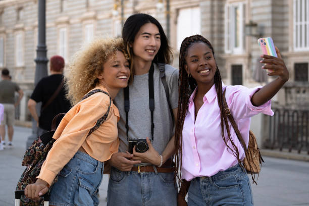 istock Multiethnic tourists young friends taking a selfie while visiting madrid city 2173963758
