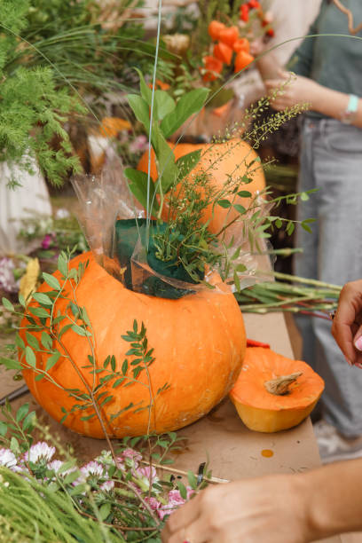 istock Creating a floral composition in a pumpkin. Making decor with your own hands. 2173967941