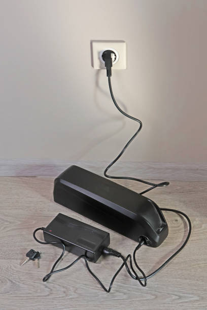 istock Charging bicycle battery from mains electricity in house. 2173971035