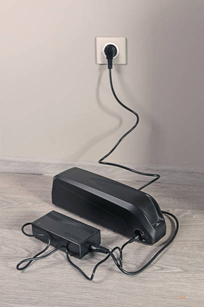 istock Charging bicycle battery from mains electricity in house. 2173971039