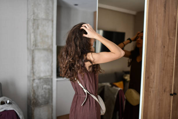 Female Getting Her Hair Looks In Order Before Going Out