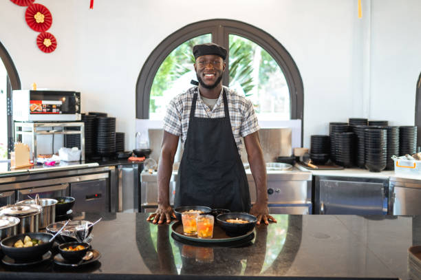 Smiling Black Chef in Asian Cuisine Eatery