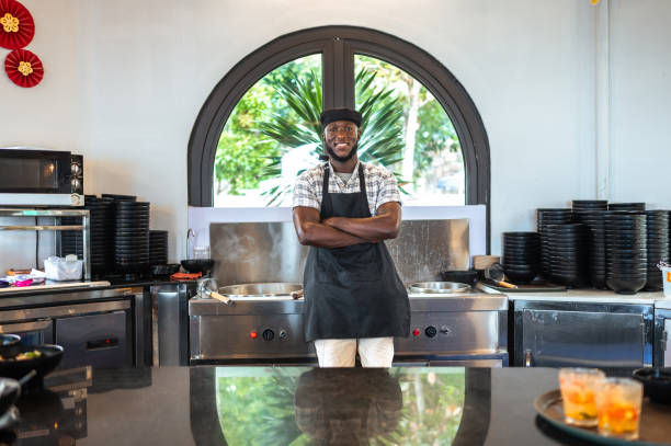 istock Confident Black Male Chef in Kitchen with Friendly Pose 2173972522