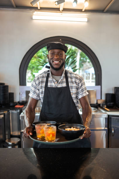 istock Smiling Black Chef Serving Food in Asian Eatery 2173972525