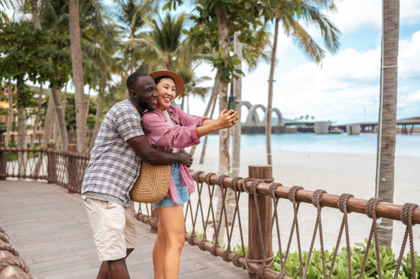 istock Multiracial Couple Enjoying Seaside Promenade Selfie 2173972802
